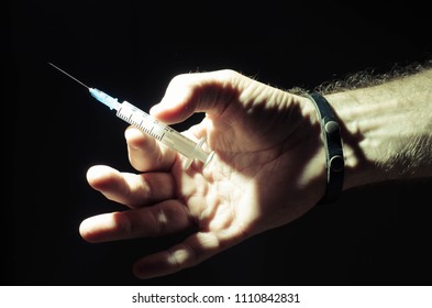 hand with syringe - Shutterstock ID 1110842831