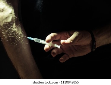 hand with syringe - Shutterstock ID 1110842855
