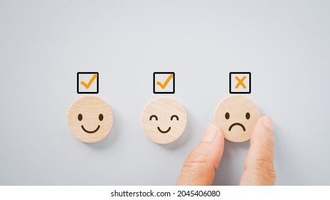 hand take off bad temper sign on small circle wood, for feedback, rating, ranking, customer review for service or product, mental health concept - Shutterstock ID 2045406080