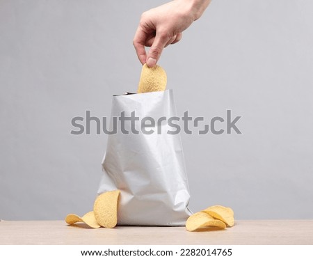 The hand takes the chips from the pack. Template for design