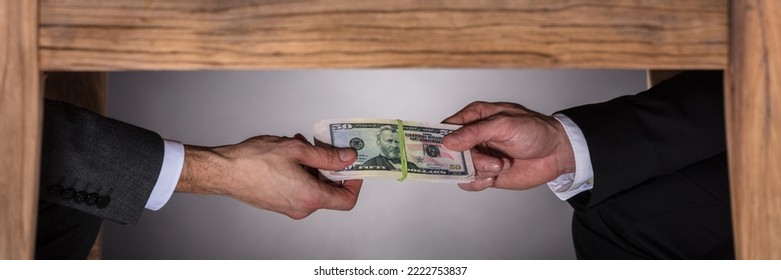 Hand Taking Bribe Under Table. Corruption Money