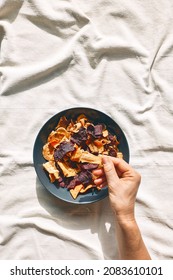 Hand Taking Crunchy Vegetable Chips From A Plate On The Table With Linen Tablecloth. Veggie Snack. Alternative Healthy Eating. Proper Nutrition. Dehydrated Vegetables