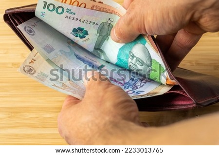 Hand taking money out of wallet, Colombia Peso banknotes, Concept, rising prices, value of Colombian currency