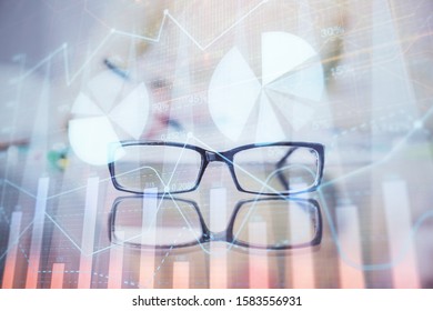 Hand taking notes in notepad. Forex chart holograms in front. Concept of research. Double exposure