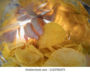 Hand Taking Potato Chips Inside The Bag.