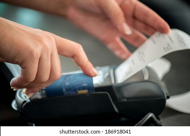 Hand Taking Receipt From Pos Terminal