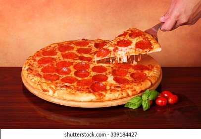 Hand Taking A Slice Of Pepperoni Pizza 