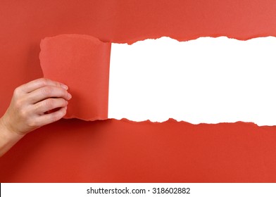 Hand Tearing Red Paper Background Revealing Copy Space