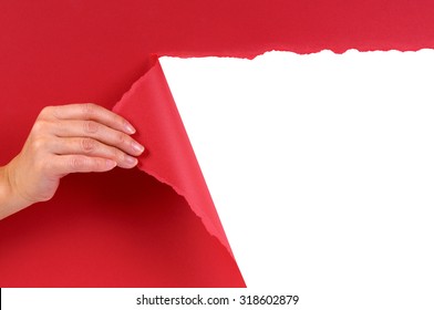 Hand Tearing Red Paper Revealing White Background.