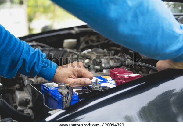 Hand of technician\
checking engine of car. Auto mechanic checking car engine.\
Maintenance checking car.