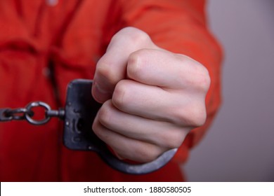 THE HAND OF A TEENAGER IN HANDCUFFS. Concept: Juvenile Delinquent, Criminal Liability Of Minors. Members Of Youth Criminal Groups And Gangs.