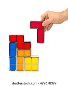 Hand With Tetris Toy Blocks Isolated On White Background