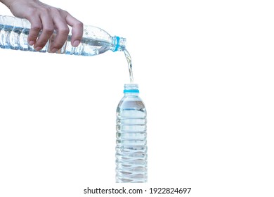 The Hand That Is Pouring Water Out Of The Bottle