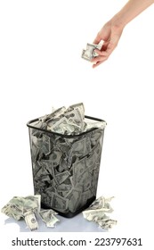 Hand Throwing Money Into Trash Can Isolated On White