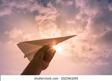 Hand Throwing Paper Airplane. Flying High In The Sky. Freedom, Travel Concept. 