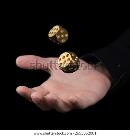 hand throwing two golden dice in the air on black background. Game with dice Gambling luck concept: bet, risk, have luck, win. lucky