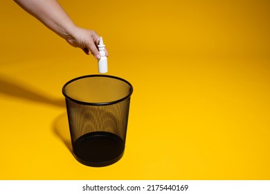 The Hand Throws The Medicine In The Form Of A Spray Into The Trash. Medicines Are Thrown Into The Office Wastebasket. The Concept Of Rising Prices For Medicine And Shortage Of Pills