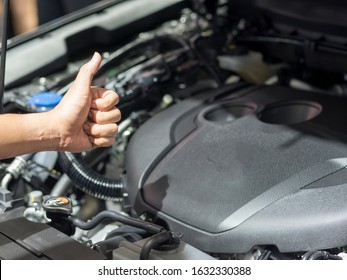 Hand thumb up with the engine of new car shiny and clean transportation concept - Shutterstock ID 1632330388
