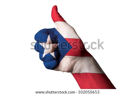 Hand with thumb up gesture in colored puertorico national flag as symbol of excellence, achievement, good, - for tourism and touristic advertising, positive political, social management of country