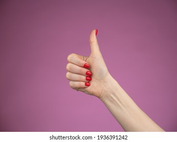 Hand With Thumb Up Isolated On Purple Background. Ok Sign By Woman