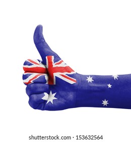 Hand with thumb up, Australia flag painted as symbol of excellence, achievement, good - isolated on white background