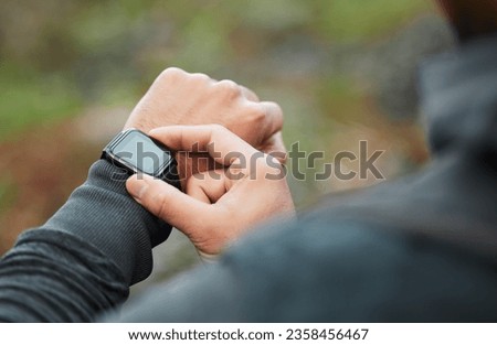 Hand, time and a man hiking in the forest closeup for freedom, travel or adventure outdoor in nature. Watch, fitness and recreation with a hiker in the woods to discover or explore the wilderness