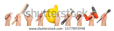 Hand tools. Hands holding construction tools isolated on white background.