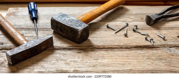 Hand Tools Old Used, Hammer, Sledgehammer Plincers And Nail On Wood, Carpenter Work Bench Table, Closeup View