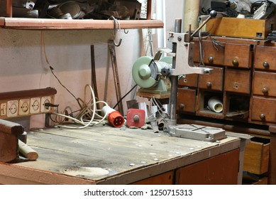 Hand tools on the table and shelf in messy home workshop 