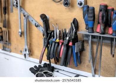 Hand tools organized on a workshop wall station for maintenance and repair tasks