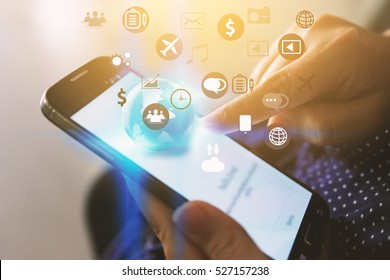 Hand touch screen smart phone. Application icons interface on screen. Social media concept - Shutterstock ID 527157238