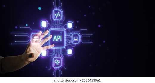 Hand touching API icon hologram, surrounded by network symbols and digital icons, on a dark background glowing with neon blue light. Technology concept