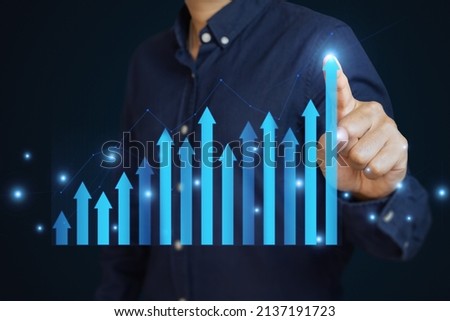 Hand is touching arrows pointing up with graph as a symbol of growth and success or rising successful development and business development in the future