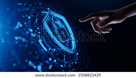 Hand touching a digital shield icon. Cyber Security and Data Protection concept