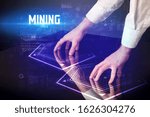 Hand touching digital table with MINING inscription, new age security concept