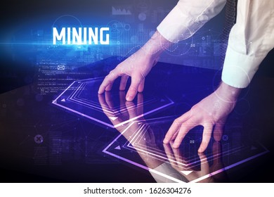 Hand touching digital table with MINING inscription, new age security concept