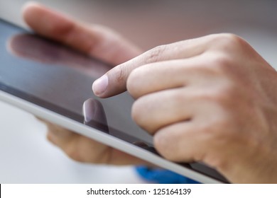 hand touching a digital tablet