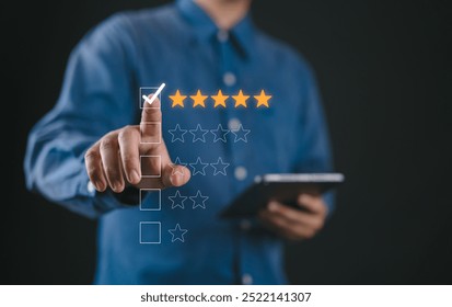 Hand touching and doing mark to five yellow stars on black background, the best customer satisfaction and evaluation for good quality product and service.