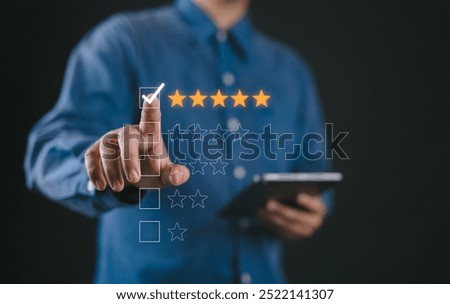 Hand touching and doing mark to five yellow stars on black background, the best customer satisfaction and evaluation for good quality product and service.