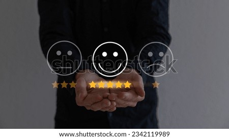 Hand touching and doing mark to select smiley face icon for evaluate product and service, customer satisfaction concept.