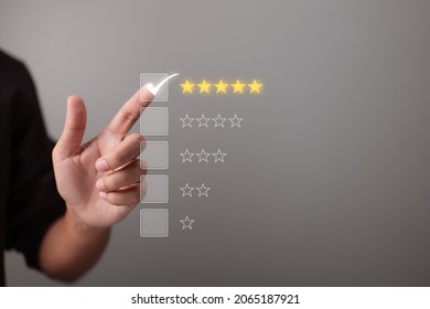 Hand touching and giving five yellow stars indicates the highest level of customer satisfaction and evaluation for a high-quality product and service. - Shutterstock ID 2065187921