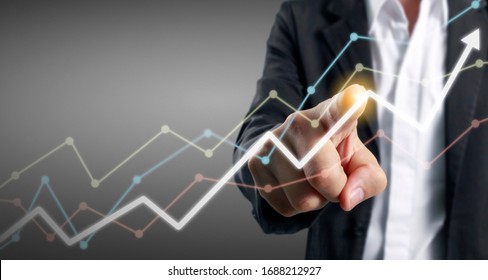 Hand touching a graphs of financial indicator and accounting market economy analysis chart
