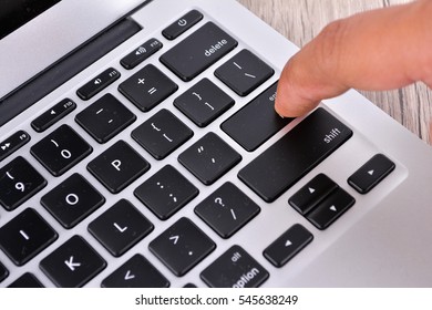 Hand touching laptop computer keyboard - Focus on the keyboard - Shutterstock ID 545638249