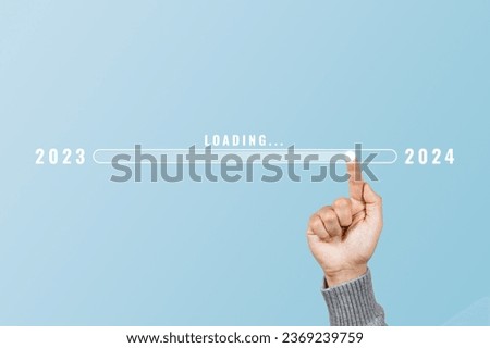 Hand touching loading bar for countdown to 2024. Loading year 2023 to 2024. Start concept
