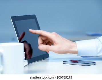 Hand touching on modern digital tablet pc at the workplace. - Powered by Shutterstock