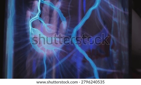 Hand touching plasma globe generating electric light arcs and static electricity