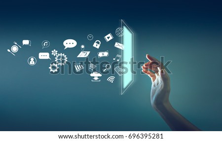 the hand touching the screen with a lot of icon throw out from screen, technology about internet of thing concept.