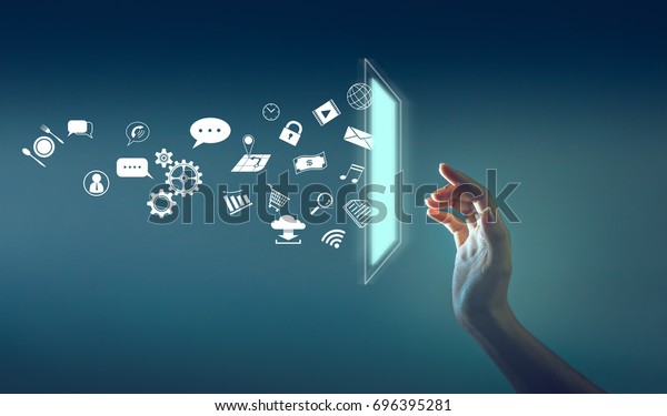 the hand\
touching the screen with a lot of icon throw out from screen,\
technology about internet of thing\
concept.