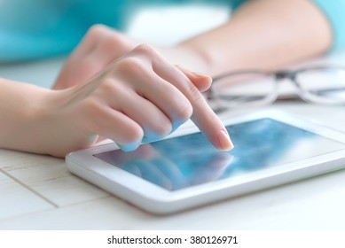 Hand touching screen on modern digital tablet pc.