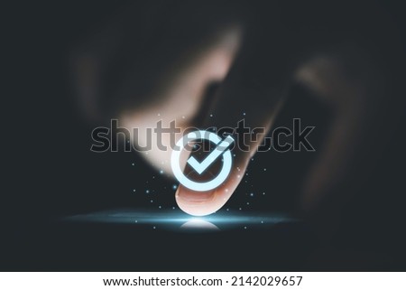 Hand touching to screen with tick correct mark to approve document and project concept.